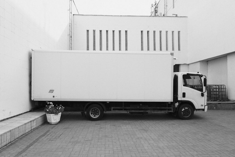 A plain white box truck parked side-on, the kind we run.